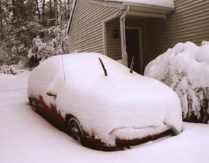 A photo of my Saturn SC2 covered in 18 inches of snow