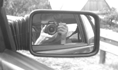 A photo of me in the side mirror of a car